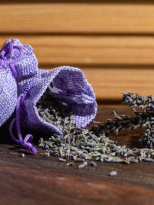 Aroma sachet with lavender flowers on a wooden background. close up.